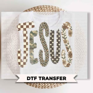 May include: A DTF transfer featuring the word JESUS in large letters. Each letter has a unique pattern: a brown and white checkerboard, green camouflage, brown leopard print, black with white polka dots, and a beige floral print on a white background.