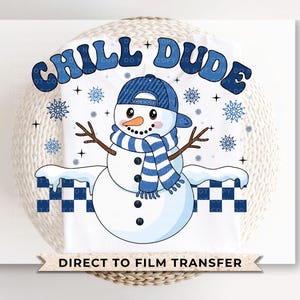 May include: A white t-shirt with a blue and white snowman wearing a blue hat and scarf. The text "Chill Dude" is written in a retro font above the snowman. The text "Direct to Film Transfer" is written below the snowman.