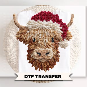 May include: A DTF transfer featuring a textured illustration of a Highland cow with long brown fur, wearing a red and white Santa hat. The design includes a cream-colored pom-pom on the hat and two curved horns, presented on a white background.