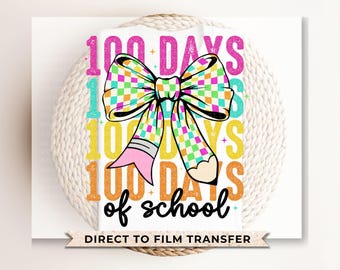 May include: A white iron-on transfer design featuring a colorful bow with a pencil design and the text "100 Days of School".