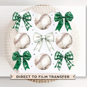 May include: A white t-shirt with a green and white bow, baseballs, and the text "DIRECT TO FILM TRANSFER".