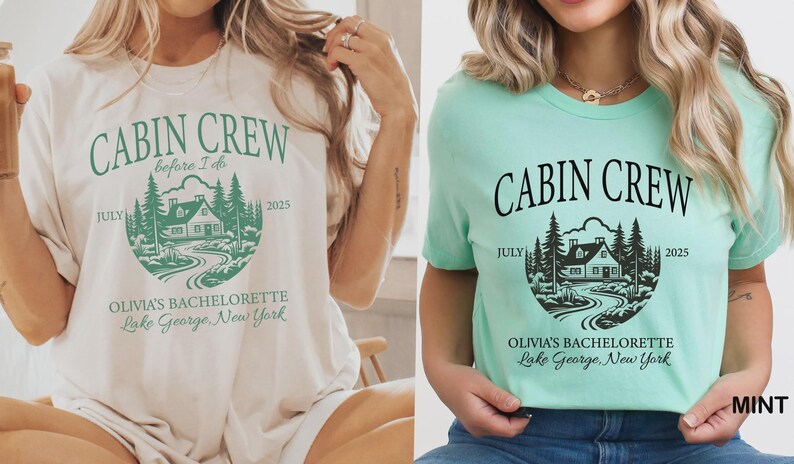 May include: Two short-sleeve crew neck t-shirts, one cream with green ink and one mint green with black ink. Both feature a graphic of a cabin in the woods with the text CABIN CREW, before I do, JULY 2025, OLIVIA'S BACHELORETTE, and Lake George, New York.