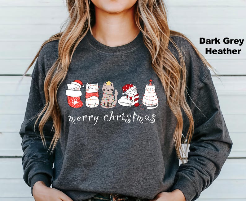 May include: Dark grey heather long-sleeve sweatshirt with a graphic of five cats wearing Christmas hats and the text "merry christmas".