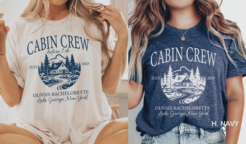 May include: Two short-sleeve t-shirts, one cream and one navy blue, featuring a circular graphic of a cabin in the woods with the text CABIN CREW, before I do, JULY 2025, OLIVIA'S BACHELORETTE, and Lake George, New York printed in a contrasting color.