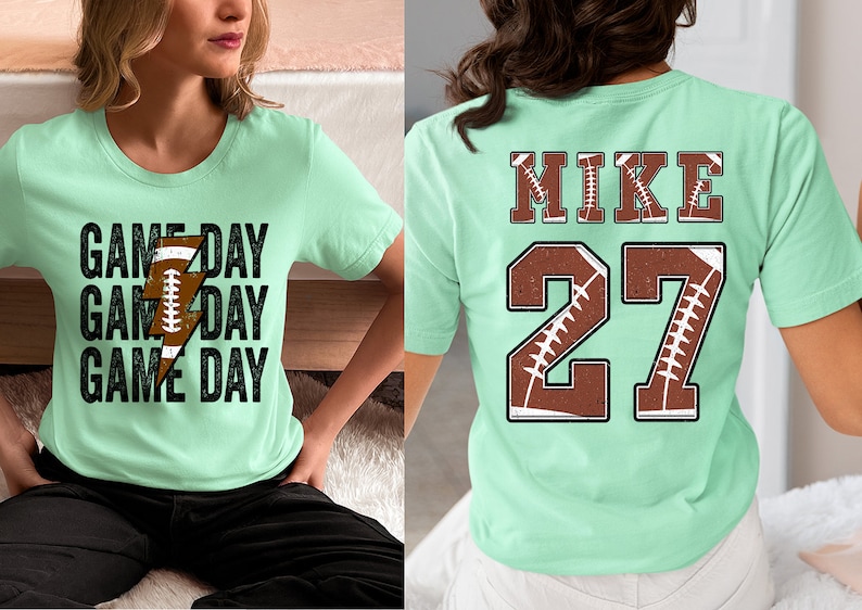 May include: Two mint green t-shirts with a football theme. One shirt has the text "GAME DAY" repeated three times with a football graphic. The other shirt has the text "MIKE 27" with football graphics.