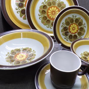 May include: A set of three ceramic mugs with a speckled, matte finish. The mugs are in shades of cream, light gray, and dark gray. Each mug has a simple, minimalist design, perfect for coffee or tea.