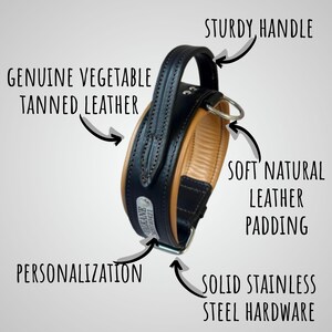 May include: A black and tan leather dog collar with a sturdy handle and stainless steel hardware. Features include soft natural leather padding and genuine vegetable tanned leather. The collar is designed for personalization.