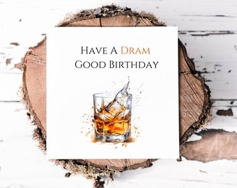 May include: A white card with the text "Have a Dram Good Birthday" and a watercolour illustration of a glass of whisky with ice cubes.
