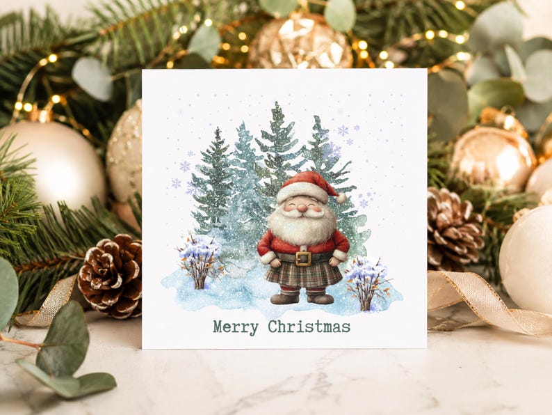 May include: A square greeting card featuring a watercolour illustration of a smiling Santa Claus wearing a red coat and a plaid kilt, standing in a snowy forest with pine trees. The text Merry Christmas is printed in dark green at the bottom.