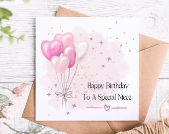 May include: A pink and white birthday card with a watercolour background and pink heart balloons. The card says "Happy Birthday To A Special Niece".