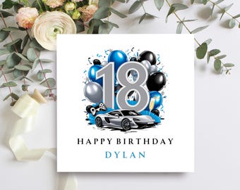 May include: A white card with a blue and silver 18th birthday design. The number 18 is surrounded by balloons and confetti. A silver sports car is in the bottom of the design. The text "Happy Birthday Dylan" is printed on the card.