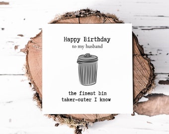 May include: A white card with a black and white illustration of a bin and the text "Happy Birthday to my husband the finest bin taker-outer I know".