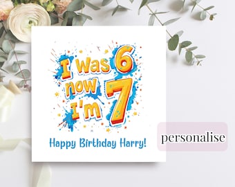 May include: A white birthday card with the text "I was 6 now I'm 7" in orange and blue. The card also says "Happy Birthday Harry!" in blue. The card has a colorful, playful design.