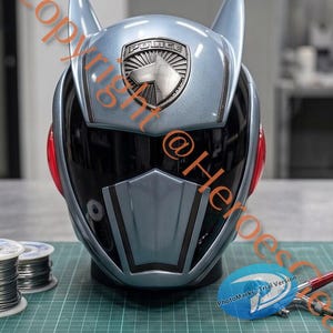 May include: A metallic light blue full-face helmet featuring two pointed cat-like ears on top, a dark tinted visor, and a central silver badge with the word POLICE and a dog silhouette. The helmet has red circular side accents and a chin guard.