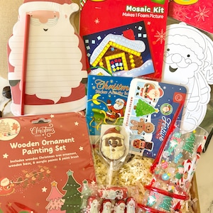 May include: A holiday gift box containing a Santa-shaped notepad, a Crayola Mosaic Kit, a Christmas sticker activity book, a wooden ornament painting set, a Santa-shaped chocolate lollipop, four Santa-themed sweets, and a festive patterned glass.
