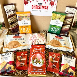 May include: A Christmas gift box containing two Galaxy instant hot chocolate sachets, Taylors of Harrogate coffee bags, two Daelmans stroopwafels, a bag of mini marshmallows, two Walkers shortbread finger packs, and a Merry Christmas chocolate bar.