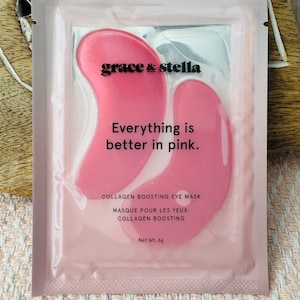 May include: A rectangular pink packet containing two pink collagen boosting eye masks. The text reads grace & stella, Everything is better in pink., COLLAGEN BOOSTING EYE MASK, MASQUE POUR LES YEUX COLLAGEN BOOSTING, and Net Wt. 6g.