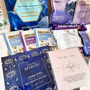 May include: A gift box filled with self-care items. Includes face masks, tea bags, eye masks, and a chocolate bar. The box contains a 'Get Well Soon' card with a small bracelet.