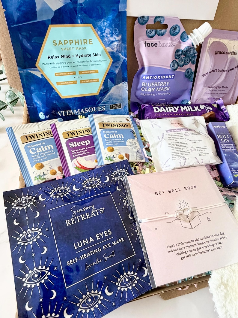 May include: A gift box filled with self-care items. Includes face masks, tea bags, eye masks, and a chocolate bar. The box contains a 'Get Well Soon' card with a small bracelet.