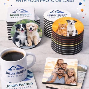 May include: Custom drink coasters featuring photos or logos. The image displays coasters with pet and family photos, and company logos. A white mug with coffee and a coaster with "Jason Holden Real Estate" are also shown.