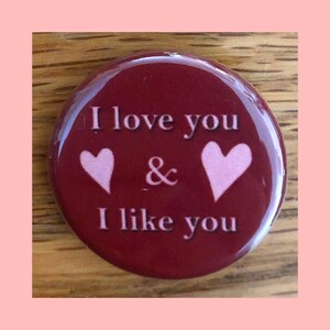 May include: A red button with the text "I love you & I like you" in white. Two pink hearts are on either side of the ampersand.
