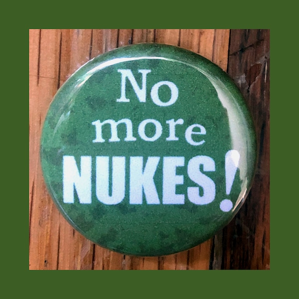 No More Nukes! 1.25" pinback button, no war, anti-war, anti-nuclear weapons, peace, resistance pin