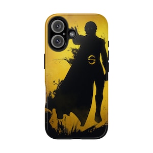 May include: A phone case featuring a black silhouette of a figure with a cape against a yellow background. The case has a dual-camera system and a black border. The design includes a circular emblem on the figure's waist.