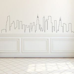 K&ouml;nnte beinhalten: Eine wei&szlig;e Wand mit einer schwarzen Umrandung einer Skyline, mit hohen Geb&auml;uden und Wolkenkratzern. Die Wand hat wei&szlig;e Wandverkleidung mit einem wei&szlig;en Teppich davor.