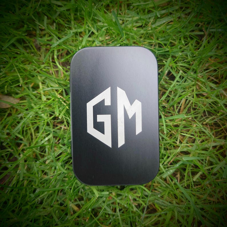 May include: A black rectangular box with a white "GM" logo in a hexagonal shape.