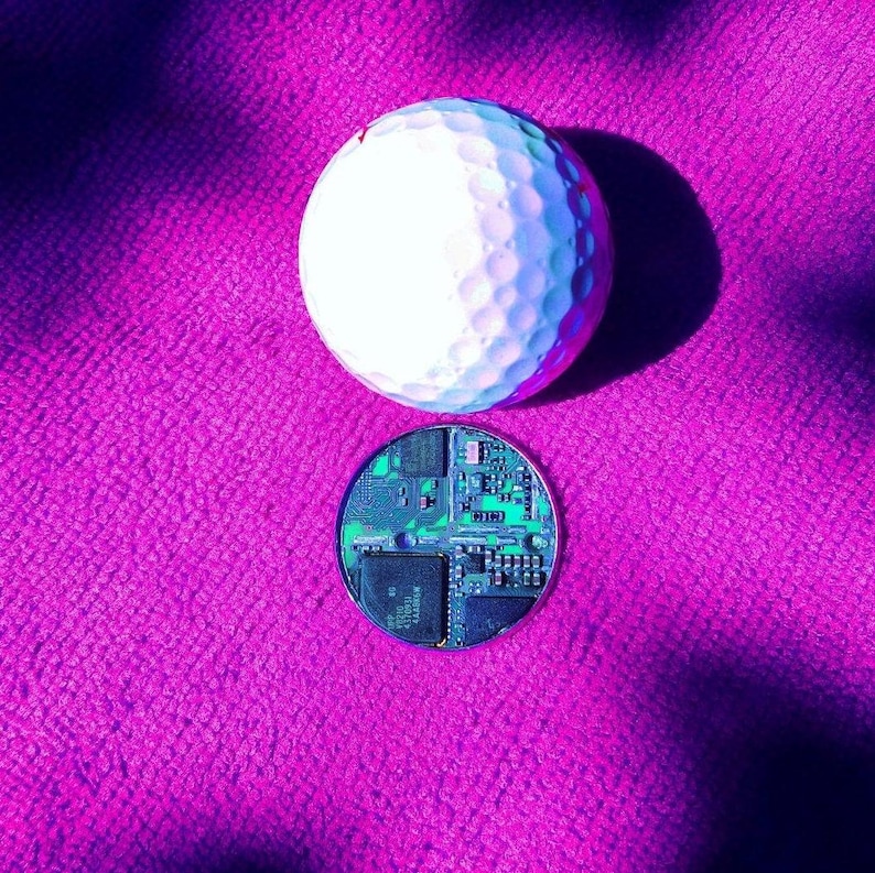 Recycled circuit board set in a round Stainless Steel bezel with laser engraved personalisation. To use as a golf ball marker, game token, decision coin.