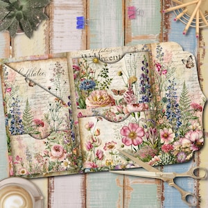 May include: A tri-fold paper organizer featuring a vintage-style floral print with various wildflowers, roses, and butterflies over a background of cursive script text. The organizer includes multiple interior pockets and is paired with gold-toned scissors.