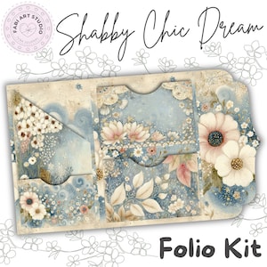 May include: A paper folio kit featuring a light blue and cream color palette with floral illustrations. The design includes pockets, a triangular corner tuck, and the text "Shabby Chic Dream" and "Folio Kit" printed on the surface.