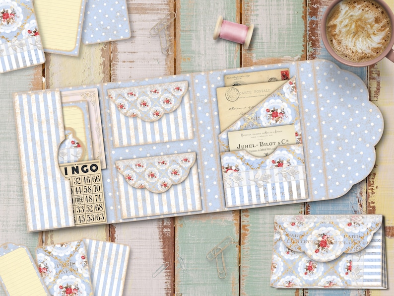 May include: A blue and white patterned paper craft project with a scalloped edge. The project has multiple pockets and a card that says "JUHEL-BILOT & Co.".