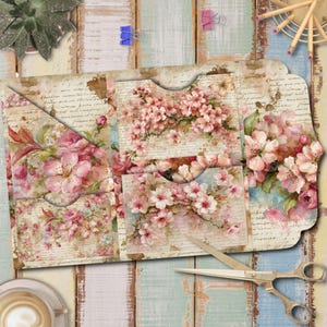 May include: A decorative paper folder featuring a vintage-style design with light pink cherry blossoms and cursive script text over a beige background. The folder includes multiple interior pockets with curved cutouts for organizing documents.