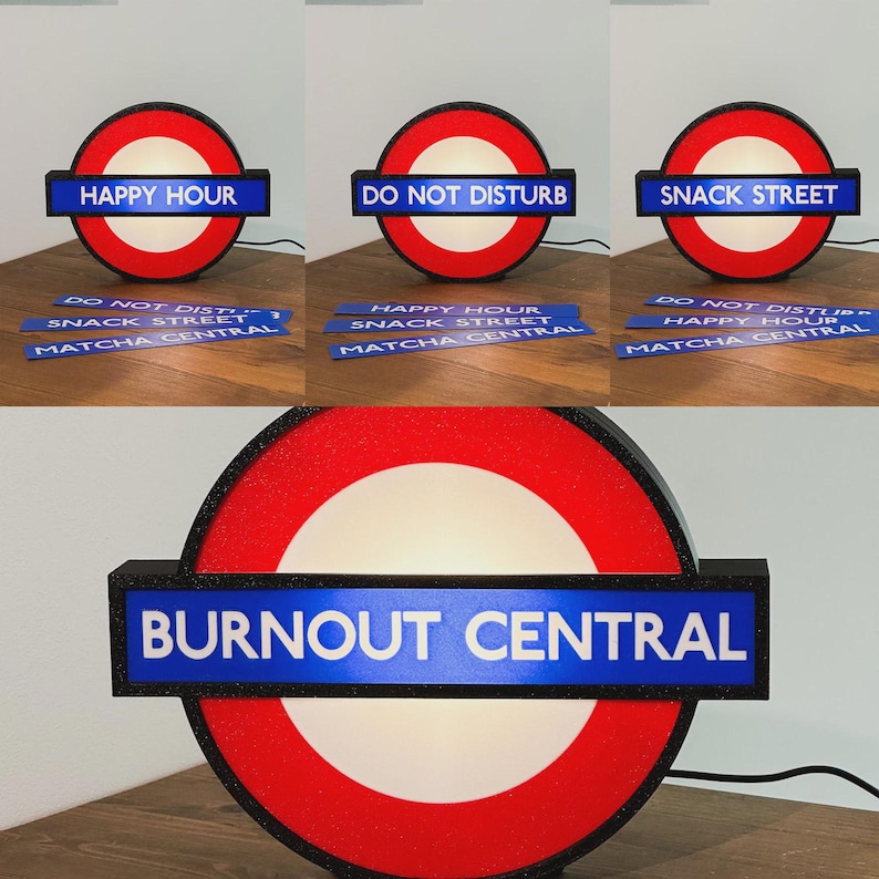 May include: A circular light-up sign featuring a red ring and a horizontal blue bar with interchangeable text inserts. The inserts display phrases including HAPPY HOUR, DO NOT DISTURB, SNACK STREET, MATCHA CENTRAL, and BURNOUT CENTRAL in white capital letters.