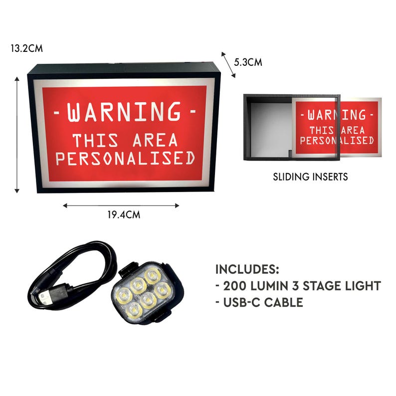 May include: A black light box with a red illuminated panel displaying "WARNING - THIS AREA PERSONALISED". Includes a 200-lumen 3-stage light and a USB-C cable. The light box is 19.4cm wide, 13.2cm tall, and 5.3cm deep.