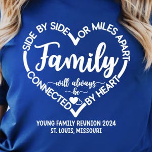 May include: A royal blue t-shirt with a white heart design that says "Side by side or miles apart, family will always be connected by heart". The text "Young Family Reunion 2024, St. Louis, Missouri" is printed below the heart.
