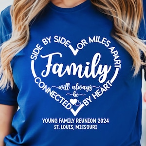 May include: A royal blue t-shirt with a white heart design that says "Side by Side or Miles Apart Family will always be Connected by Heart". The shirt also has the text "Young Family Reunion 2024 St. Louis, Missouri" printed on the bottom.