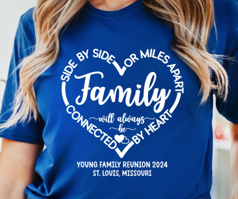 May include: A royal blue t-shirt with a white heart design that says "Side by Side or Miles Apart Family will always be Connected by Heart". The shirt also has the text "Young Family Reunion 2024 St. Louis, Missouri" printed on the bottom.