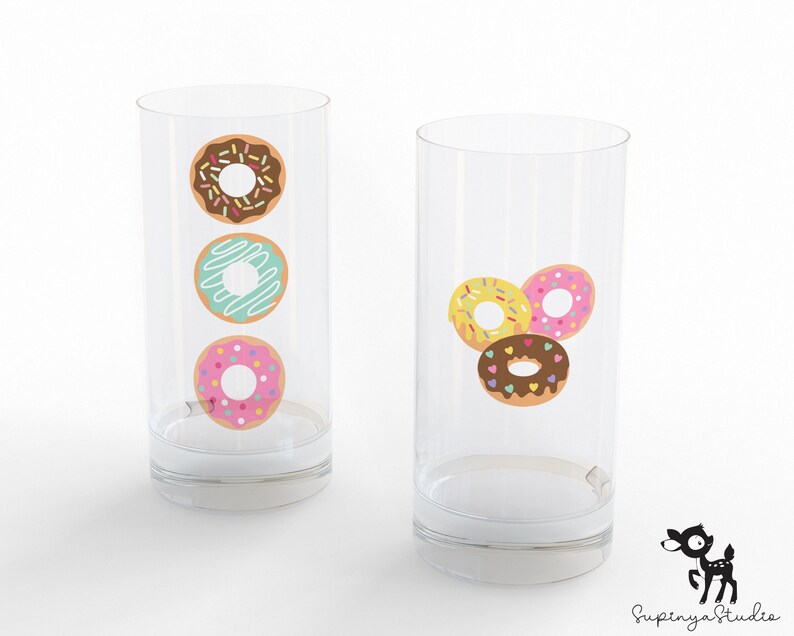 May include: Two clear glass tumblers with donut designs. One tumbler has three donuts stacked vertically, one with chocolate frosting and sprinkles, one with blue frosting and white drizzle, and one with pink frosting and sprinkles. The other tumbler has three donuts arranged in a triangle, one with yellow frosting and sprinkles, one with pink frosting and sprinkles, and one with chocolate frosting and sprinkles.