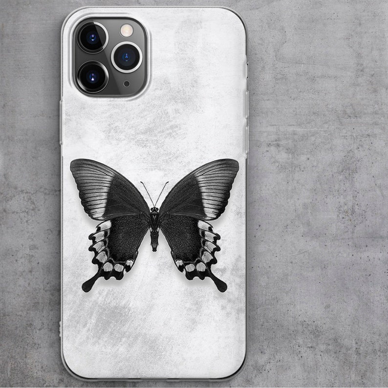 May include: A white phone case with a black butterfly design. The butterfly has white accents on its wings.