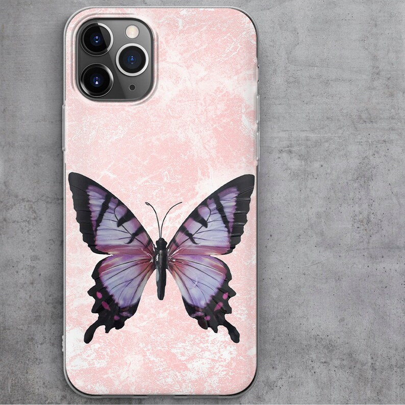 May include: A pink phone case with a white marble design and a purple butterfly in the center.