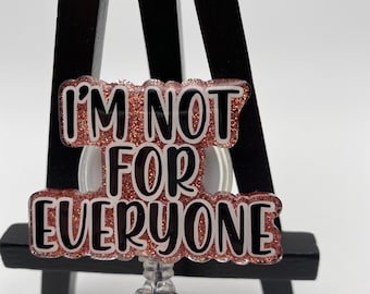 May include: A pink glitter badge holder with a black and white text overlay that reads "I'm not for everyone".