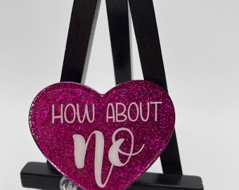 May include: Pink glitter heart-shaped badge holder with a white inscription that reads "How about no".