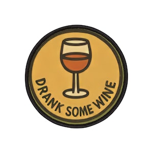 May include: A round patch with a wine glass graphic in brown and white on a yellow background. The text "DRANK SOME WINE" is in white, surrounding the wine glass. The patch has a black border.