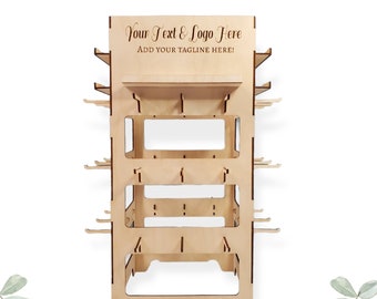 May include: A wooden display stand with shelves and hooks for displaying products. The stand is made of natural wood and has a simple, modern design. The top shelf has a sign that says "Your Text & Logo Here ADD YOUR TAGLINE HERE!"