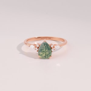 14k solid rose gold 6x8mm pear cut natural aquatic green moss agate engagement ring with tiny G Colour SI Clarity genuine diamond accent side stones on a white background