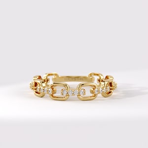May include: A gold chain link ring featuring a series of rectangular links, with alternating links encrusted with small clear stones. The interior of the band is engraved with the text LUCY'S 14K, indicating the metal composition and brand name.