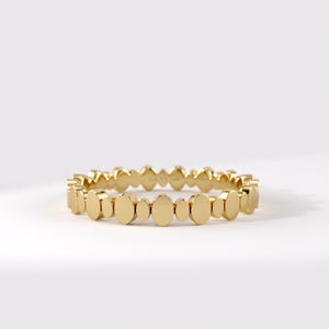 May include: A gold ring featuring a repeating pattern of alternating large and small polished oval-shaped links. The interior of the band is clearly engraved with the text LUCY'S 14K, indicating the metal purity of this circular jewelry piece.