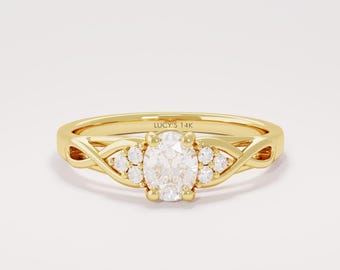 May include: A gold ring with an oval-cut diamond center stone and smaller accent diamonds. The band features an interwoven design. The text "LUCY'S 14K" is engraved on the band. This ring is a piece of fine jewelry.
